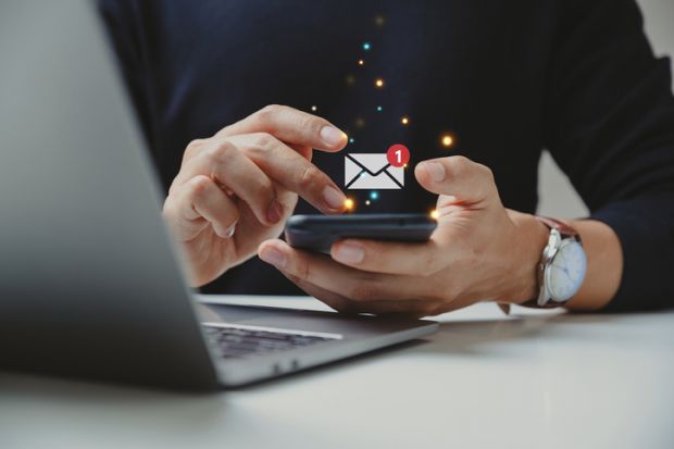 Hand of businessman using smartphone for email with notification alert